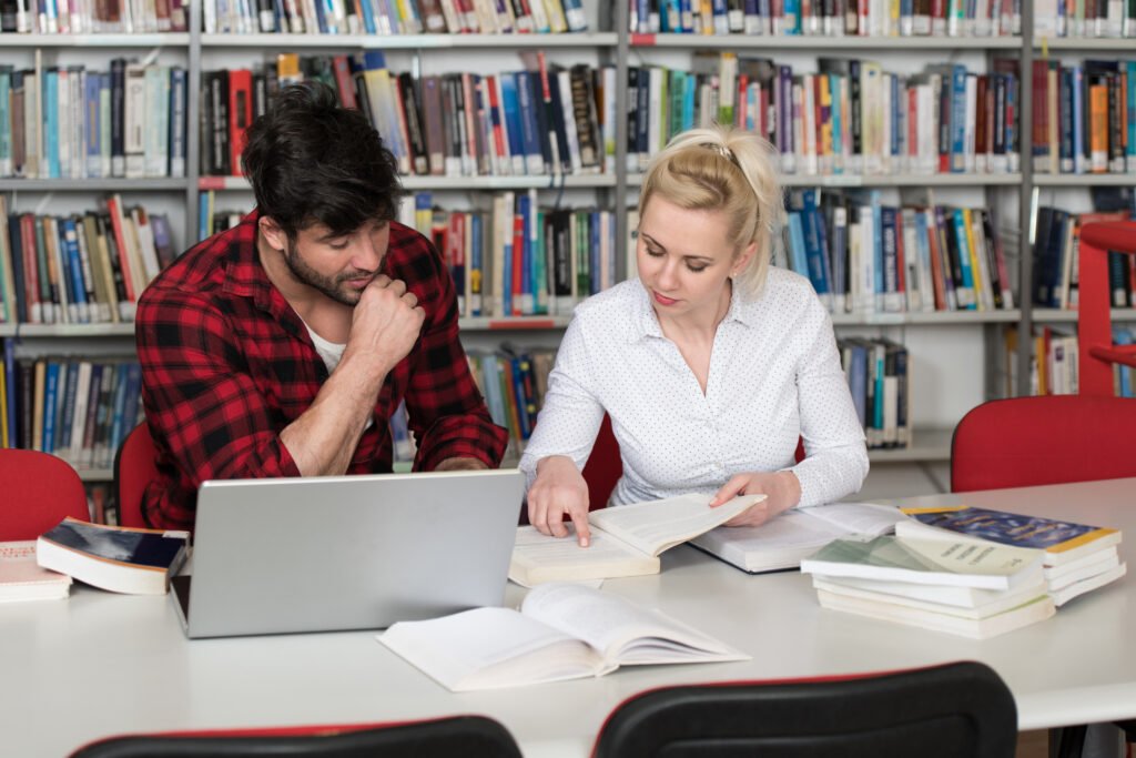 The current image has no alternative text. The file name is: portrait-attractive-students-doing-some-school-work-with-laptop-library-scaled.jpg
