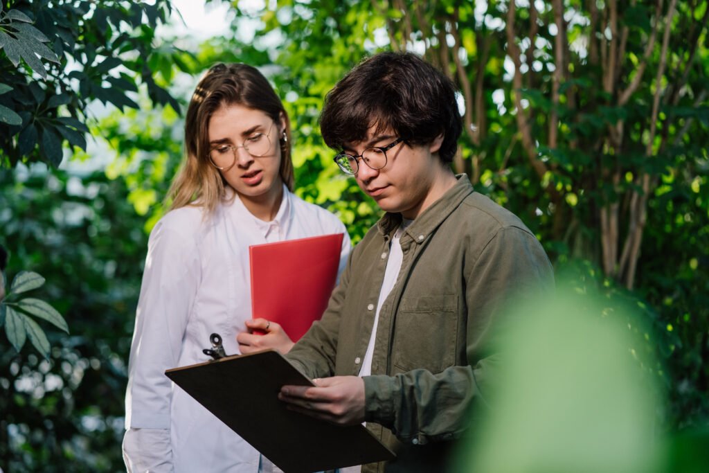 The current image has no alternative text. The file name is: young-agricultural-engineers-working-greenhouse-scaled.jpg